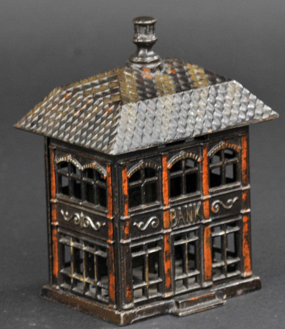 FINIAL STILL BANK: Kyser & Rex, c. 1887, intricate window effects, roof pattern done in silver and bronze striping, building is japanned. 5 3/4" h.