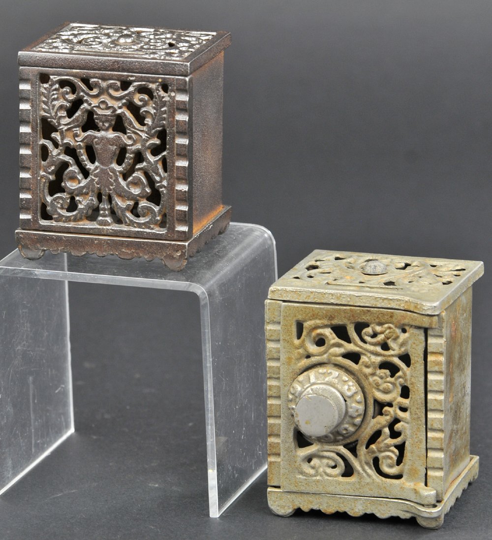 LOT OF TWO SCROLLWORK SAFE BANKS: Kenton Scrollwork Safe & nickel plated safe have ornate molding effects, Kenton has no access, other has combination lock. 2 7/8" to 3" h.