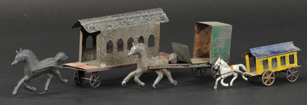GROUPING OF EARLY AMERICAN TIN TOYS: Includes horse drawn trolleys and Amish style cart, all hand painted in varied colors, minor re-solder in places. 5 3/4" to 11" l.