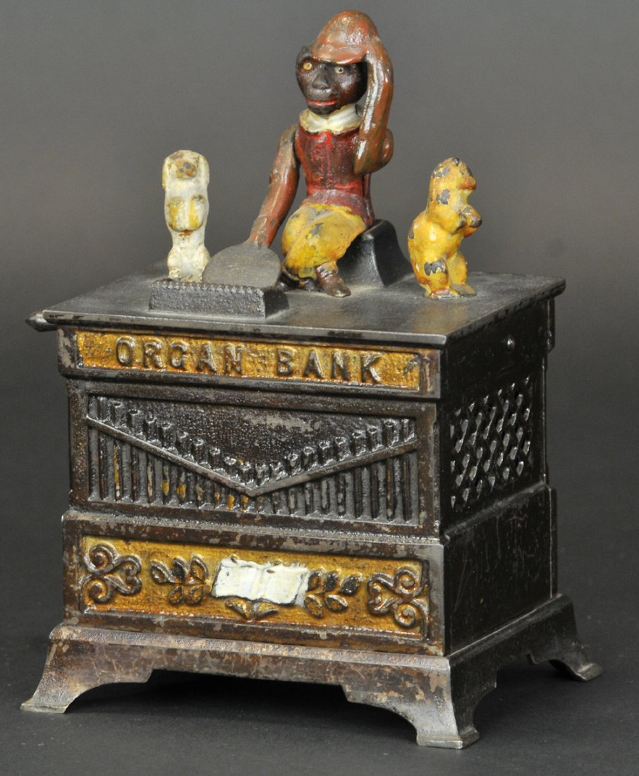 ORGAN MECHANICAL BANK (CAT & DOG): Red Jacket, Kyser & Rex Co., designed by Louis Kyser & Alfred C. Rex, patented 6/13/1882. Fitted with chime of bells and dancing figures, which revolve when the handle is turned. The monkey receives t