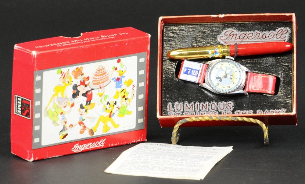 MICKEY MOUSE BIRTHDAY SERIES WRIST WATCH & BOX: c. 1948, working, U.S. Time, comes with Ingersoll pen in matching red, round face clock billed as luminous, fun night reading, price tag reads $7.55. Ex. Donald Kaufman Collection