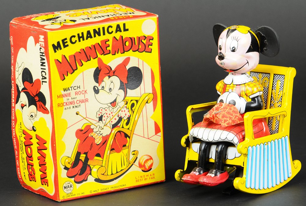 BOXED MINNIE MOUSE KNITTER: Linemar, Japan, © Walt Disney Productions, lithographed tin, detailed toy depicts Minnie seated on rocking chair with knitting needles in hand, key wind actions. 6 1/2" h.