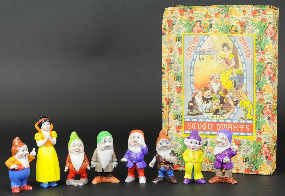 BOXED BISQUE SEVEN DWARFS FIGURES SET: Japan, Geo. Borgfeldt Dist., early pre-war set includes all seven dwarfs and larger Snow White figure, each very colorfully painted overall, box label depicts nice bright graphic imagery. Figures meas