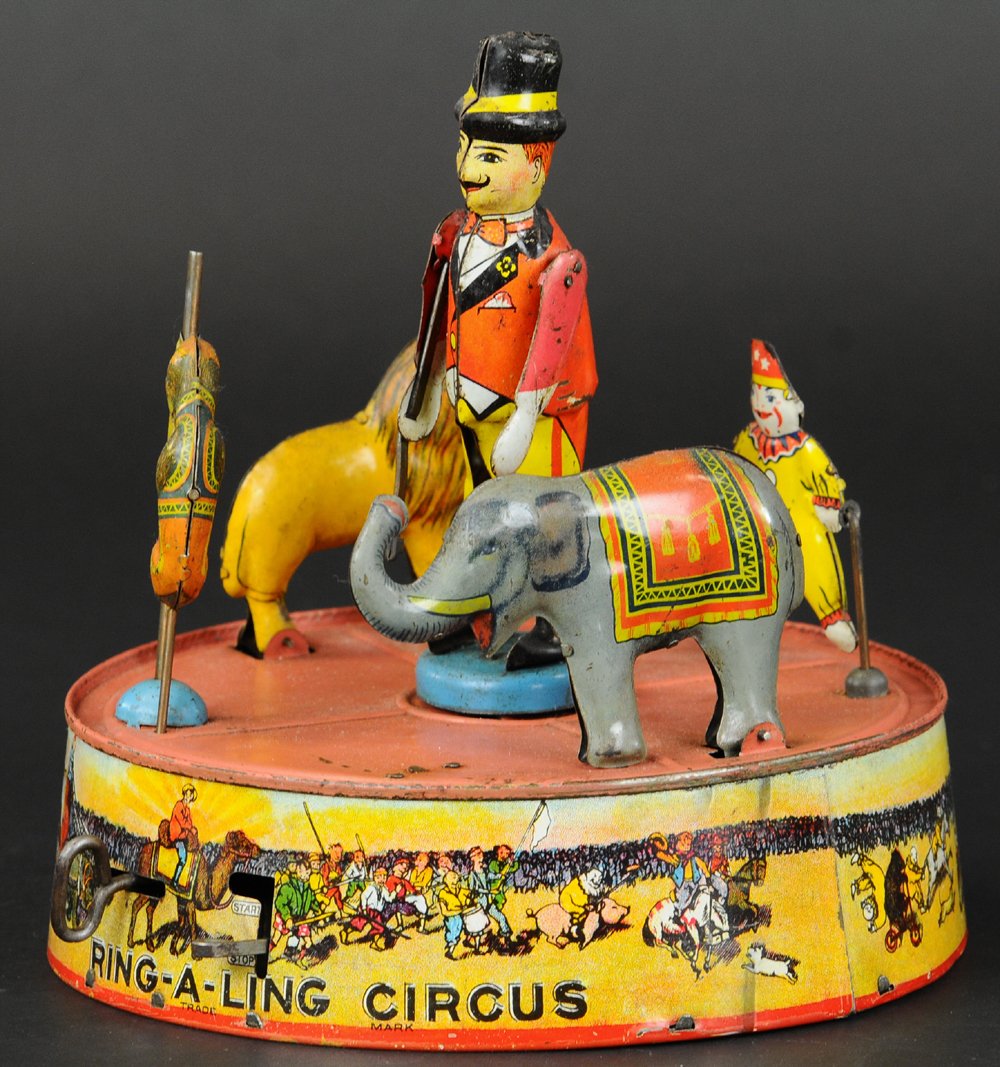 RING-A-LING CIRCUS: Louis Marx, lithographed tin, elaborate toy features circus animals together with trainer, all standing on base which is extensive clockwork action. 7 1/2" diam.