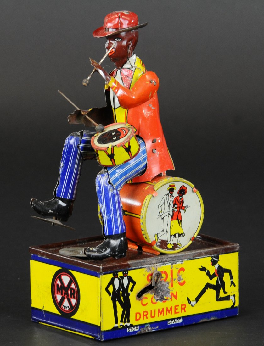 MARX SPIC DRUMMER: Lithographed tin wind-up toy, scarce single band member version, great actions, figure depicted in seated pose with instruments at the ready. 8 3/4" h.