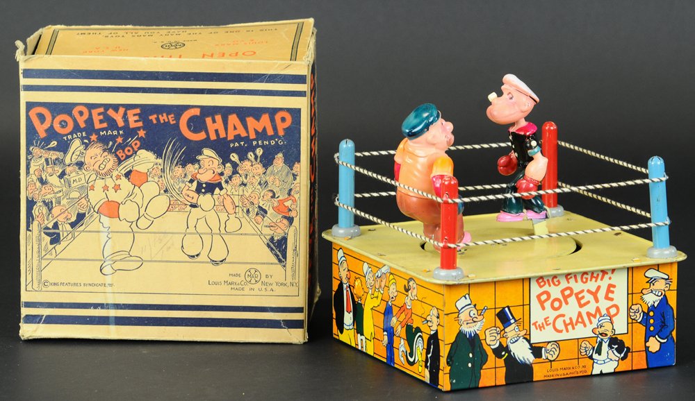 POPEYE THE CHAMP WITH BOX: Louis Marx, lithographed tin boxing ring, features tin posts and string ropes, depicts celluloid figures of Popeye and Brutus ready to swing away when clockwork is activated, very amusing toy. 7 1/4"