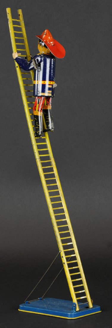 SLIPPING SAM FIREMAN: Louis Marx, lithographed tin, key wind figure able to climb extended ladder on platform. Figure 7 1/2" h.