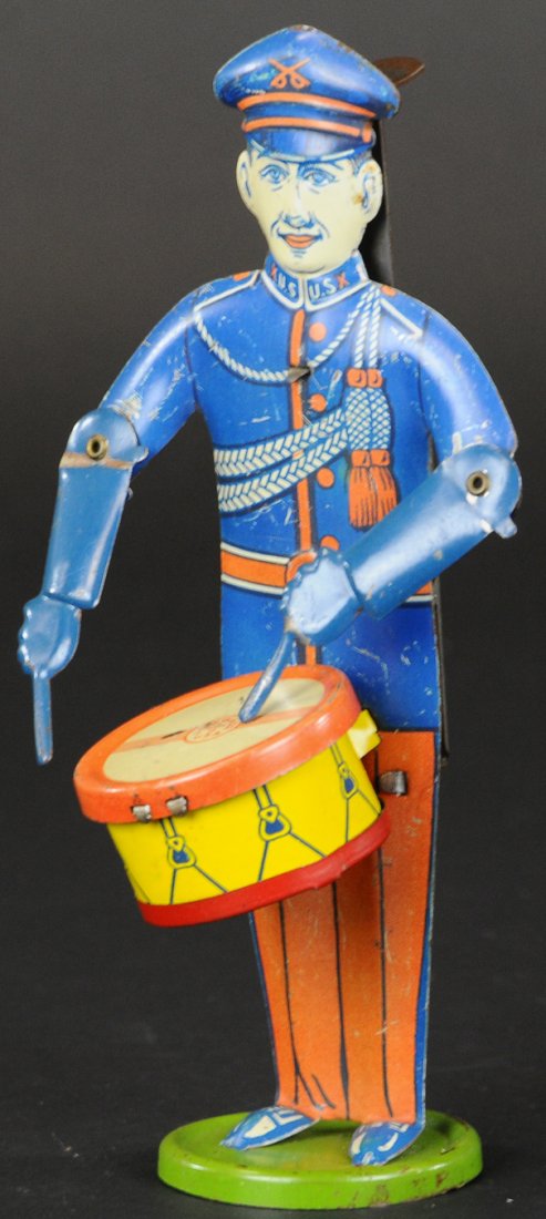 DRUMMING SOLDIER: Chein, lithographed tin, depicts U.S. parade drummer in blue suit, stamped sticks in hands, hand controlled actions, wear to drum head. 7 1/8" h.