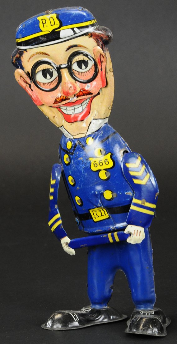 KOMICAL KOP WALKER: Louis Marx, lithographed tin, clockwork activated walking action, some scratches overall. 10 1/2" h.
