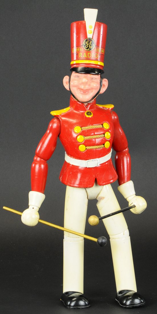 MAXFIELD PARRISH GE ADVERTISING FIGURE: c. 1920's, fully ball jointed, holds drum major's baton, full tall helmet decal with "GE" emblem and "General Electric Radio" lettering, great counter display. 18 3/4" h.