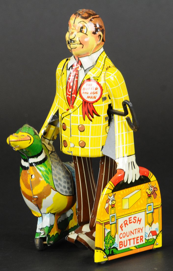 MARX BUTTER AND EGG MAN: Lithographed tin wind-up toy, a Butter and Egg man would be carrying a chicken, not a duck, but Marx didn't change the design from Joe Penner's toy; a scarce and desirable comic character addition. 7