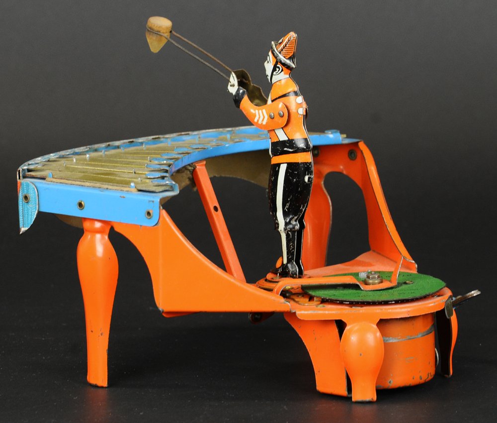 ZILOTONE: Wolverine Mfg., tin and pressed steel musical toy depicts figure at play on zilotone, colorful keyboard, orange instrument, clockwork mechanism activates spinning records and drumming motion by figure