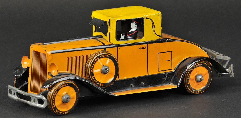 MARX COUPE: Lithographed tin, done in orange body, yellow roof, black and orange running boards, seated driver, fold-down luggage rack. 12" to luggage rack.