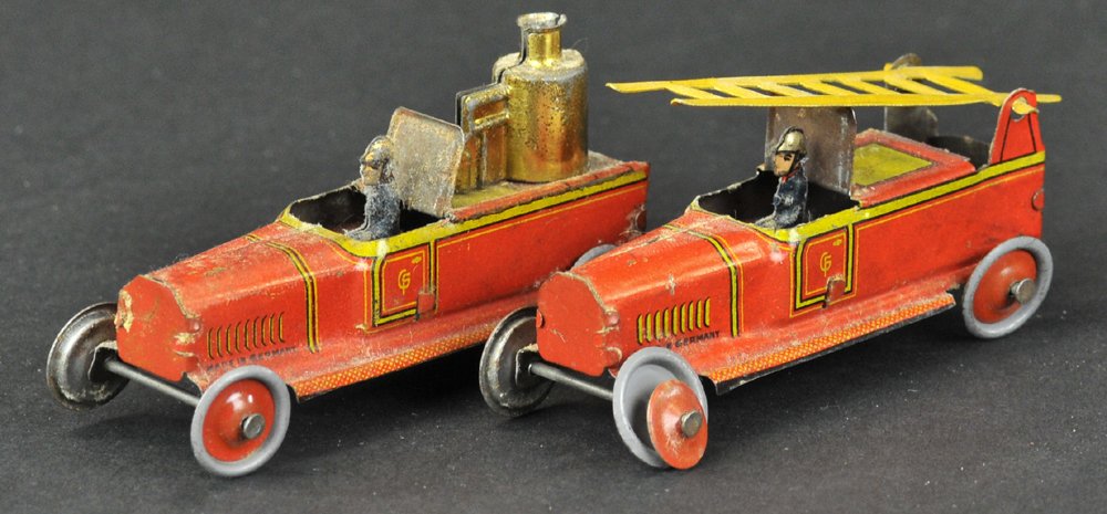 LADDER AND FIRE TRUCK PENNY TOYS: Kellermann, Germany, embossed lithographed tin, red trucks, one has yellow trim and ladder, other contains boiler on open body. 3" l.