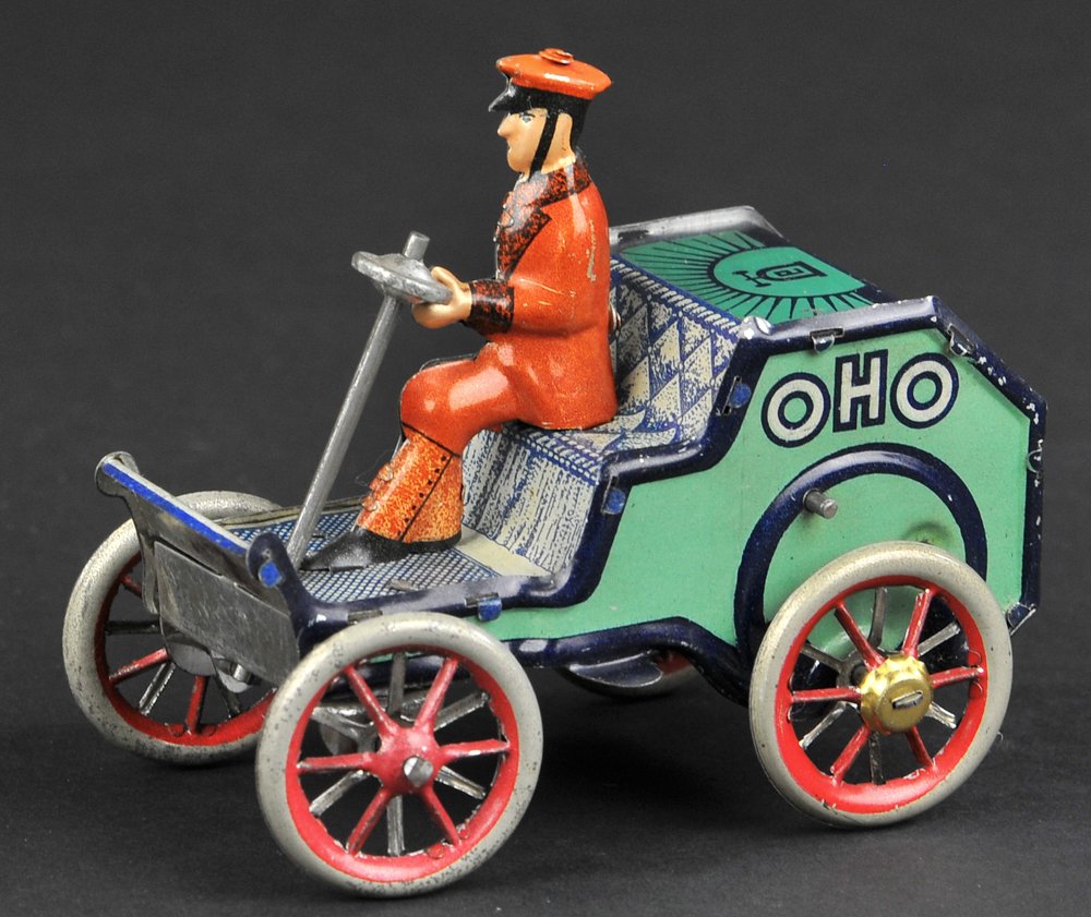 LEHMANN OHO: Germany, open cap automobile, lithographed tin, done in green with seated driver, reads "Oho" on sides, clockwork mechanism. 3 3/4" long.
