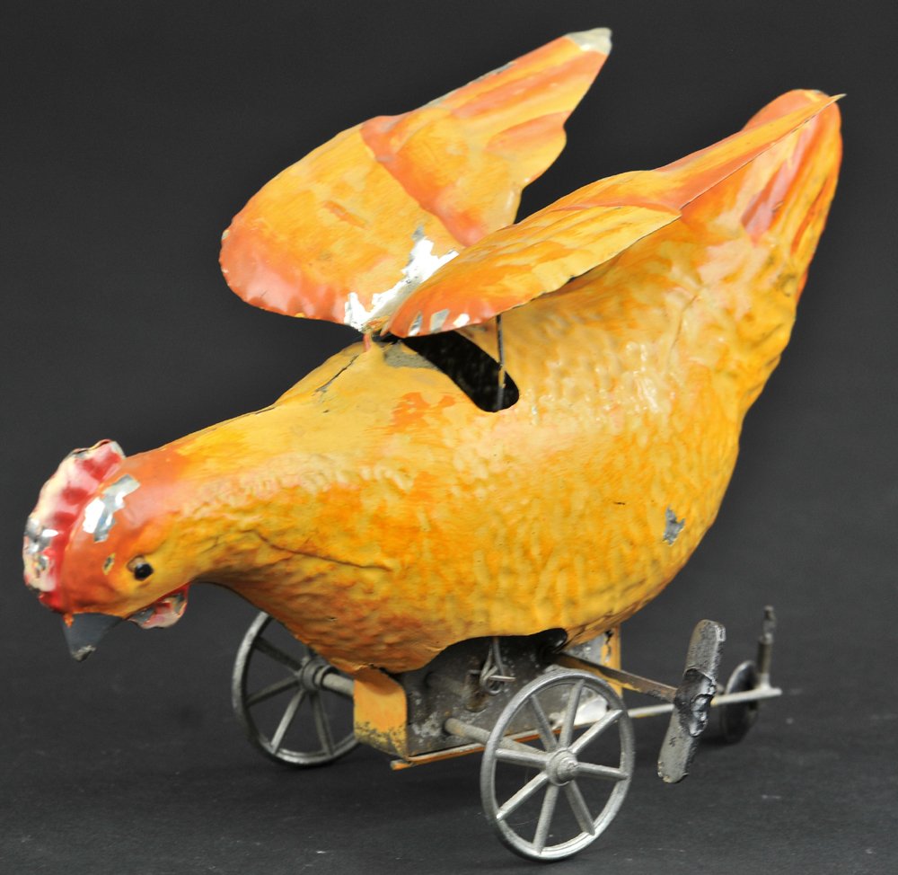 GUNTHERMANN CHICKEN: Germany, hand painted, done in hues of brown, red comb, spoke wheels, features clockwork flapping wing action and emits sounds. 6 3/4" l.