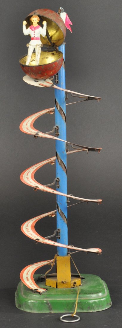 MYSTERY BALL TOY: Ferdinand Martin, France, lithographed tin, clockwork driven, one of the most interesting of table top toys, spiral track allows ball to travel to top and suddenly open to reveal figure posed inside. 