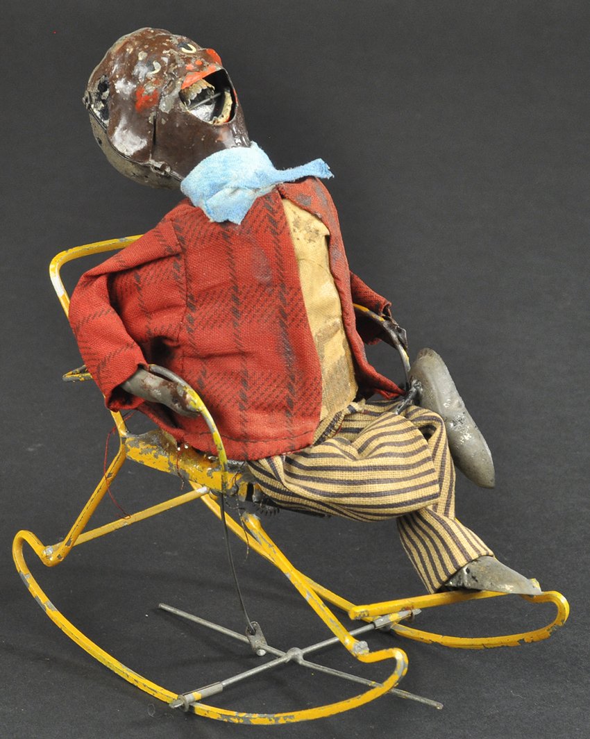 MAN IN ROCKING CHAIR: Gunthermann, Germany, hand painted figure, seated with one leg crossed, amusing facial expression, clockwork activated, wire chair, cloth outfit, very early example. 6" h.