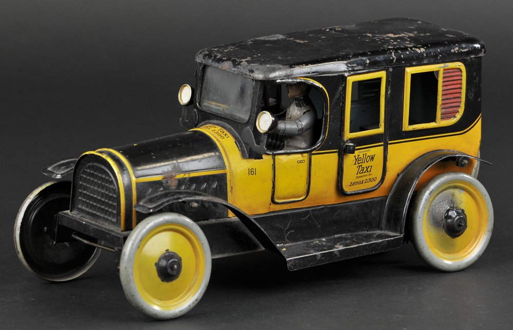 KARL BUB YELLOW TAXI: Germany, lithographed tin, done in orange and black body, doors read "Yellow Taxi," features seated driver and interior vacant sign, clockwork driven. 9 3/4" l.