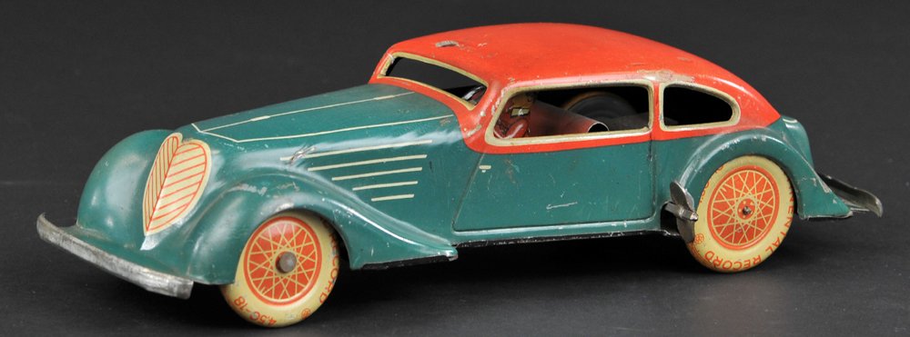 KARL BUB COUPE: Germany, lithographed tin, non-opening two-door example done in green body, red roof, tin wheels with spoke graphics, light tin bumpers, key wind operated. 10" l.