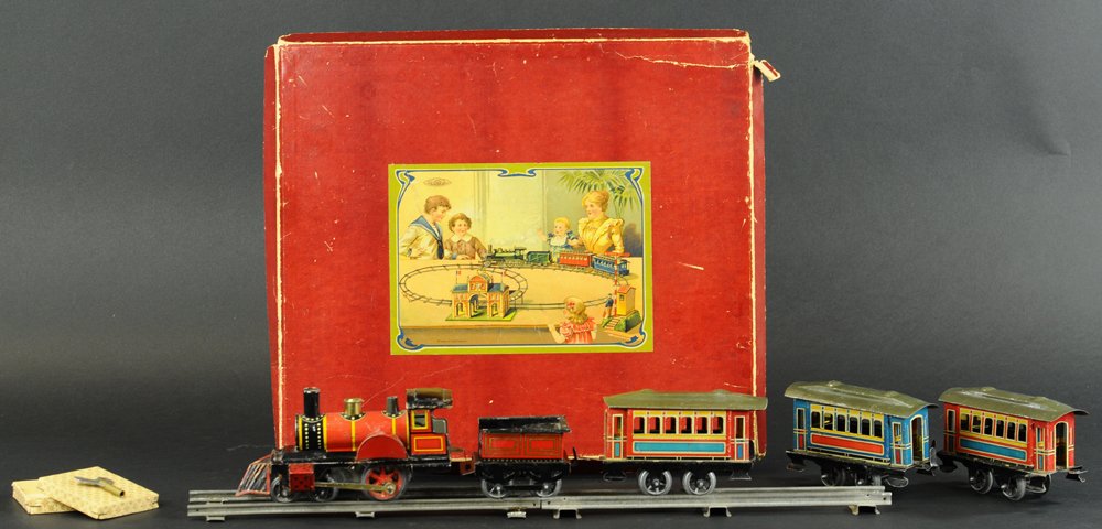 ISSMAYER BOXED PASSENGER TRAIN SET: Lithographed tin, includes American profile 4-2-0 clockwork locomotive with tender pulling three four wheel passenger coaches, done in multi-colored bodies of red, yellow, and blue color schemes with