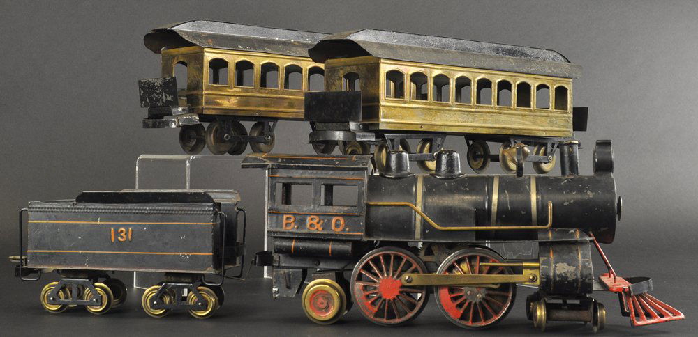 CARLISLE & FINCH #34 LOCOMOTIVE & PASSENGER SET: Train set lot includes a black "B & O" 4-4-2 #34 locomotive and black tender with orange stripes, together with two brass body cars, each with black roofs and eight wheels. Cars 15 1/2" l.