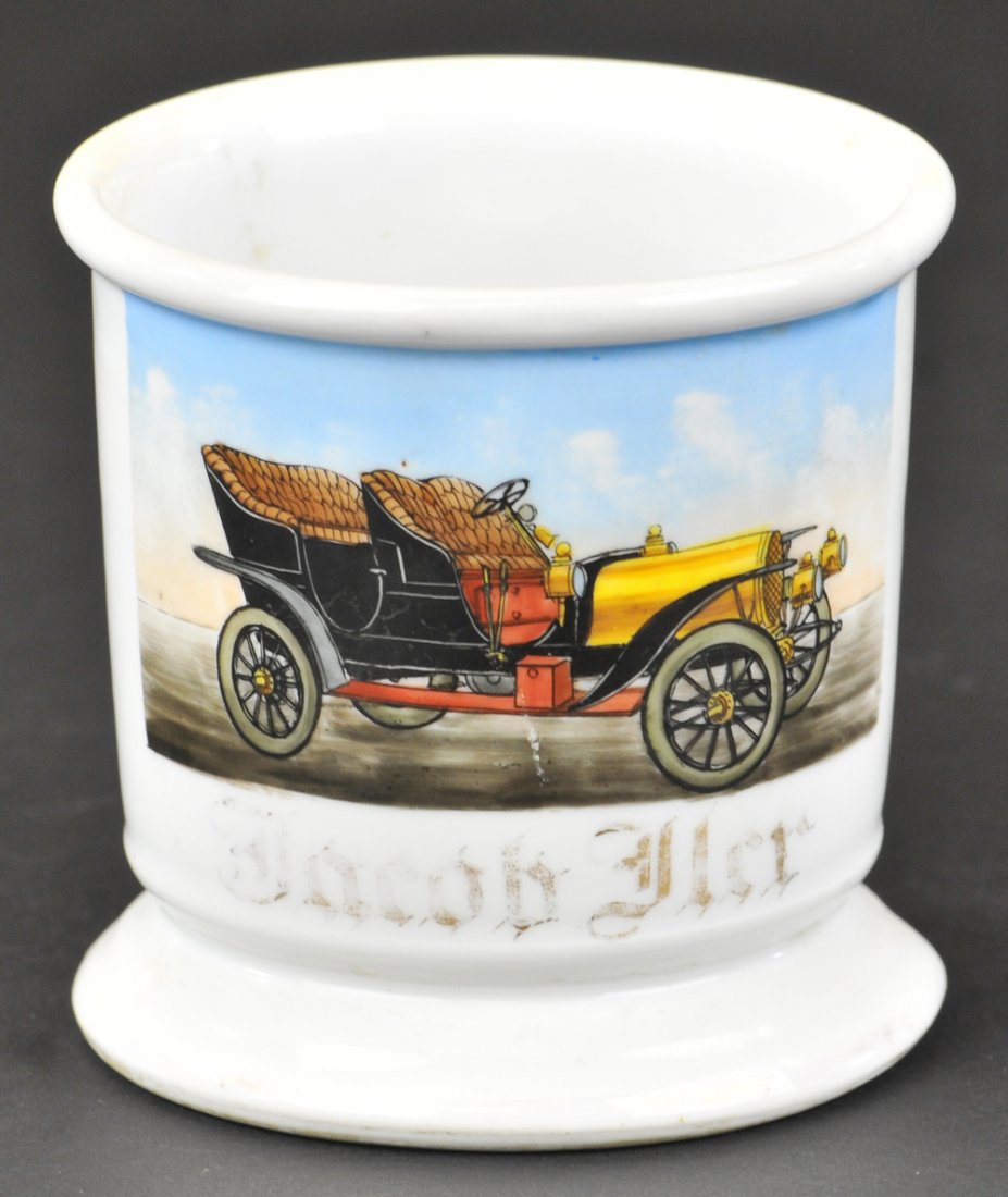 FOUR SEAT OPEN AUTO OCCUPATIONAL SHAVING MUG: Unmarked, well detailed illustration of open Phaeton with upholstered seating, side lamps, headlamps, and tool box on running boards, early spoke wheel auto has no driver, gold gilt lettered, "Jacob F