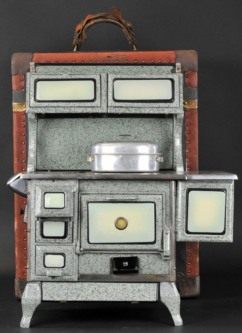 WROUGHT IRON RANGE CO. SALESMAN'S SAMPLE W/CASE: St. Louis, porcelainzed example, grey and green mottled colors, exceptional detail for the company's "HOME COMFORT" Line, reservoir on side, opening doors, includes company catalog carry case. 17" w.