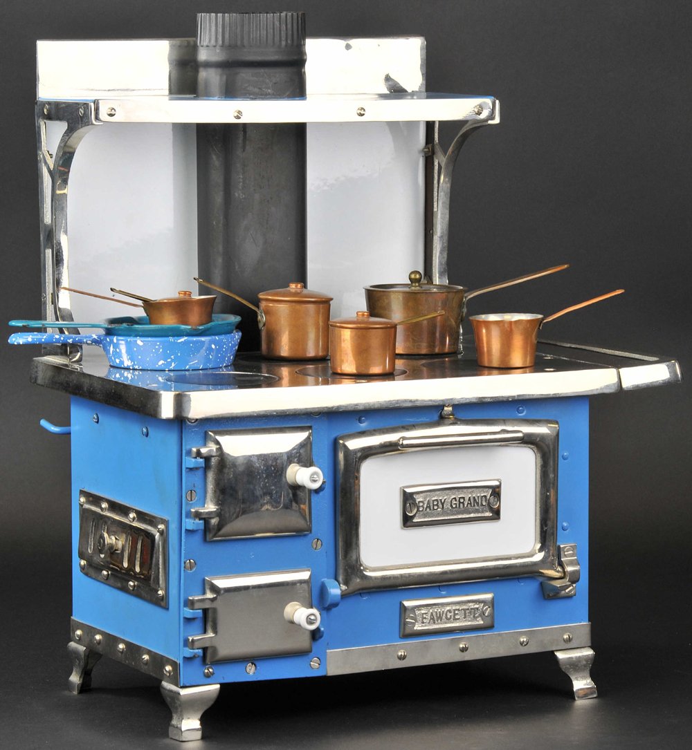 BABY GRAND RANGE: Charles Fawcett Mfg., elaborate example with full backsplash, painted in blue overall, white back and extensive nickel plated doors and handles, features upper shelf, and pipe at center. 12" h.