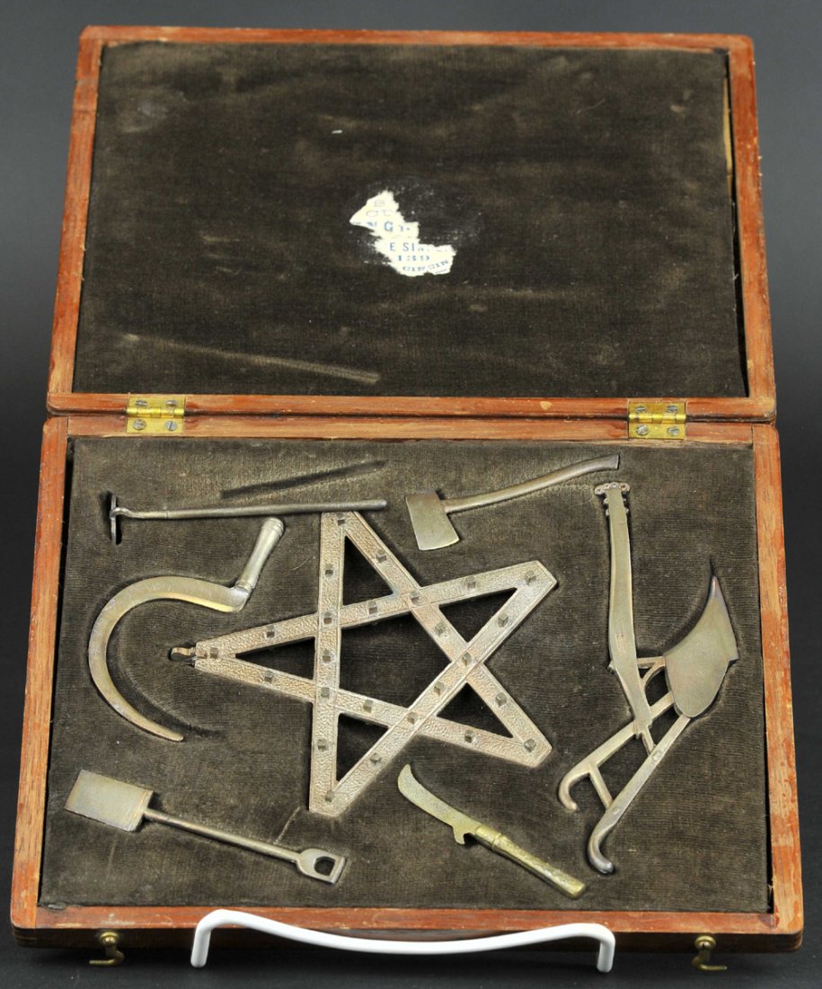 SALESMAN'S SAMPLE MINATURE TOY WITH CASE: Jas. Murdock, Cinn., OH, top metal tag reads, "P of H," die-cast toy implements include: shovel, sword, ax, sickle, hoe, and plow, all contained in custom carry case, copper color finished toys, very 