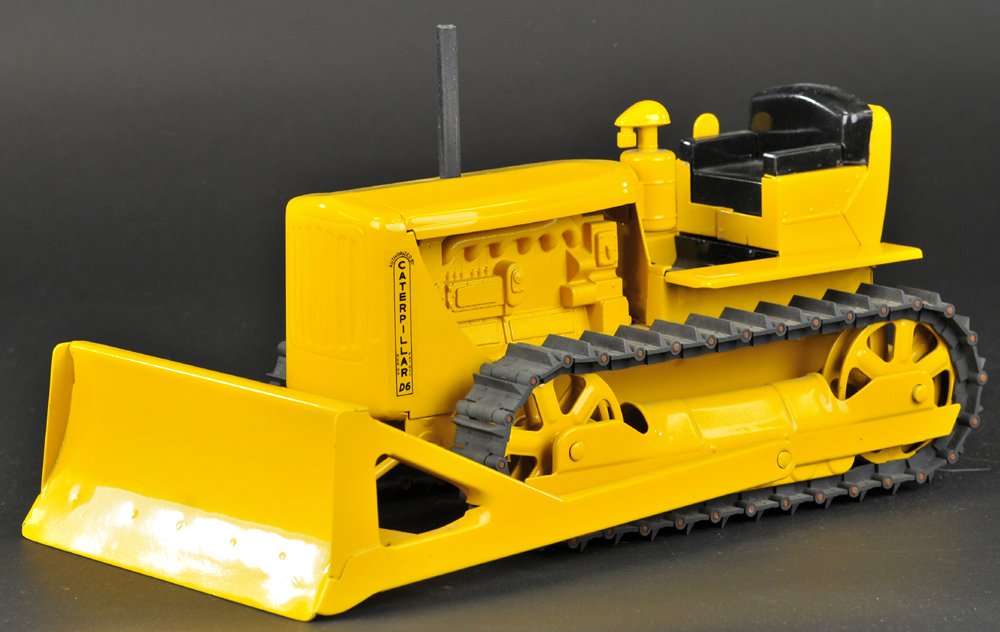 DOEPKE CATERPILLAR BULLDOZER: 1950's, painted in yellow overall, pressed steel with plastic components, includes original stack and treads. 15" l.