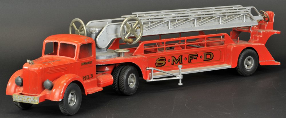 SMITH MILLER L-MACK LADDER TRUCK: Red tractor with red trailer containing extension ladder on swivel base, large hand control levers, decals read, "S.M.F.D." on sides, No.3, original paint. 35" l.