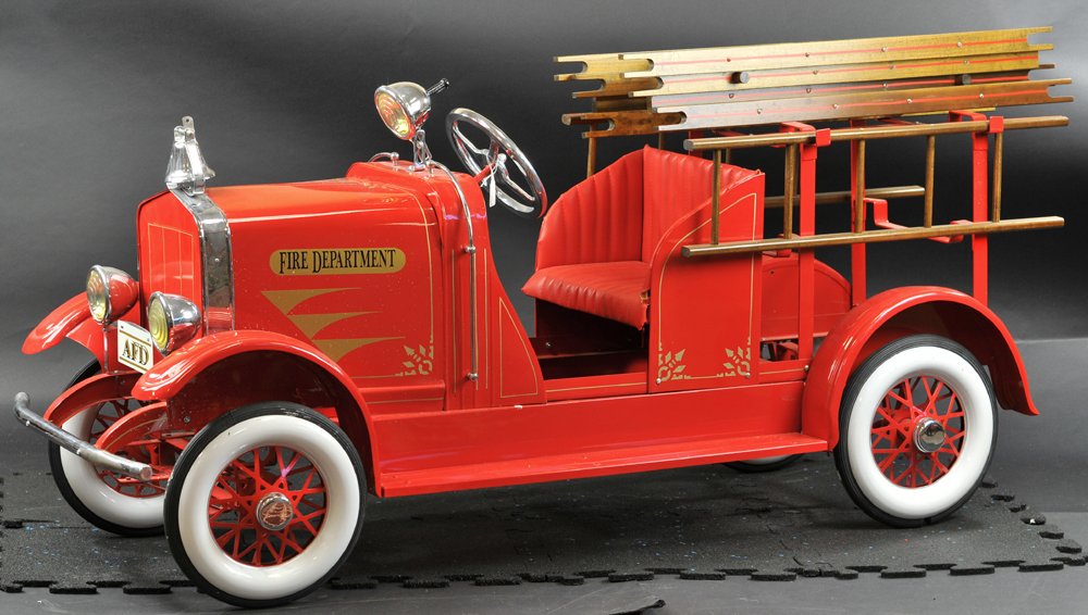 AMERICAN NATIONAL LADDER TRUCK PEDAL CAR: Impressive scale, pressed steel body, painted in classic fire engine red, fully appointed with headlights, spotlight, supports and wooden ladders, white and red metal wheels with rubber tires, full de