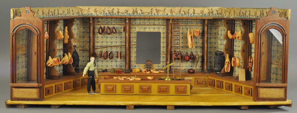 KITCHEN DISPLAY ROOM BOX: Large scale room box display with open front, interior reveals extensive detailed shelving for assorted hanging meats, ample table space for butcher's cutting tools, ladder on side, colorful wallpaper