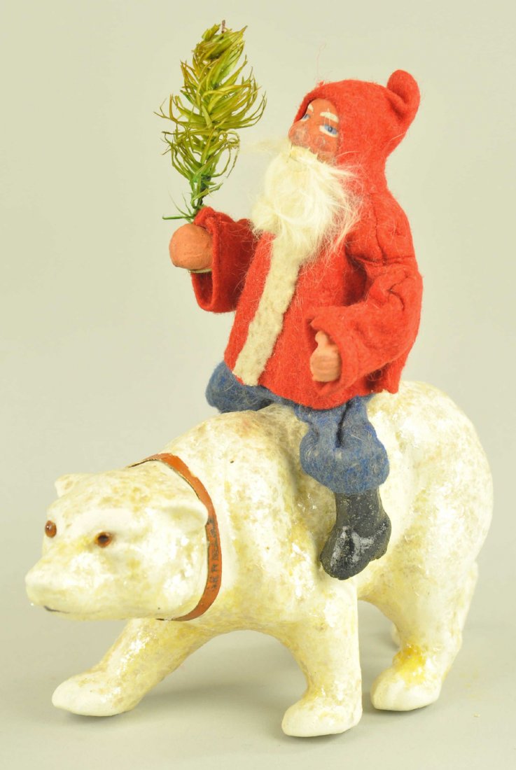 SANTA ON COMPOSITION POLAR BEAR: Germany, composition Santa with red felt coat & blue pants, feather tree sprig in hand riding a chalk-like polar bear with mica & glass eyes. 7" h.