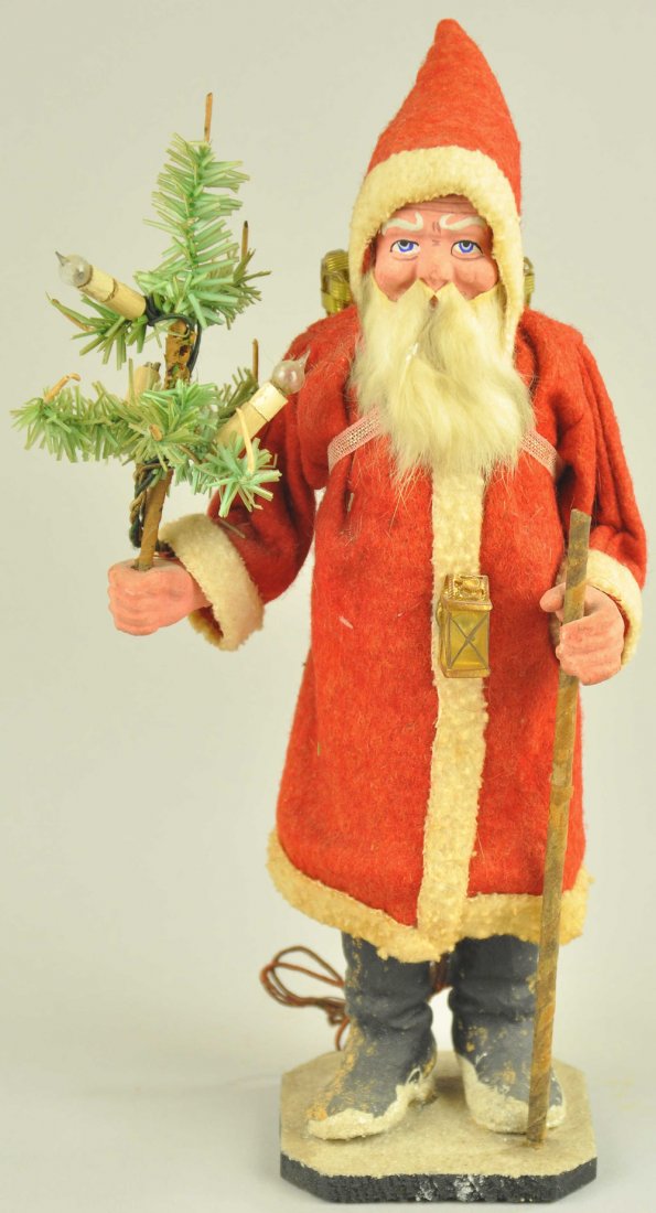 ELECTRIFIED SANTA CLAUS WITH WALKING STICK: Germany, red felt robe w/white trim, metal back pack, carrying a feather tree with electric candles and a lantern at his waist, unique design. 10" h. Ex. Tom Fox Collection.
