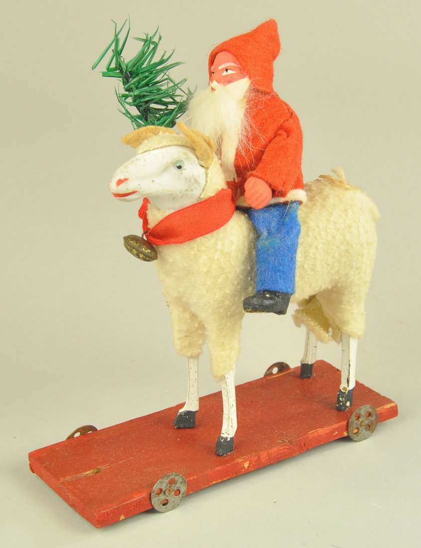 SANTA CLAUS ON SHEEP PULL TOY: Germany, Santa on sheep platform toy, wearing red coat with blue pants, composition face with rabbit fur beard, feather tree spring on stick leg, sheep with chalk face, nice details. 6" l.