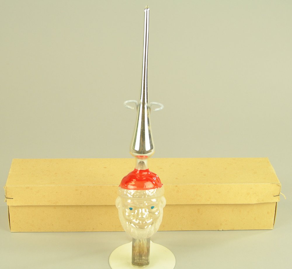 BOXED SANTA TREE TOPPER GLASS ORNAMENT: Germany, blown glass Santa head spear, Santa has a crushed glass beard and red cap, still in original box. 11" h.