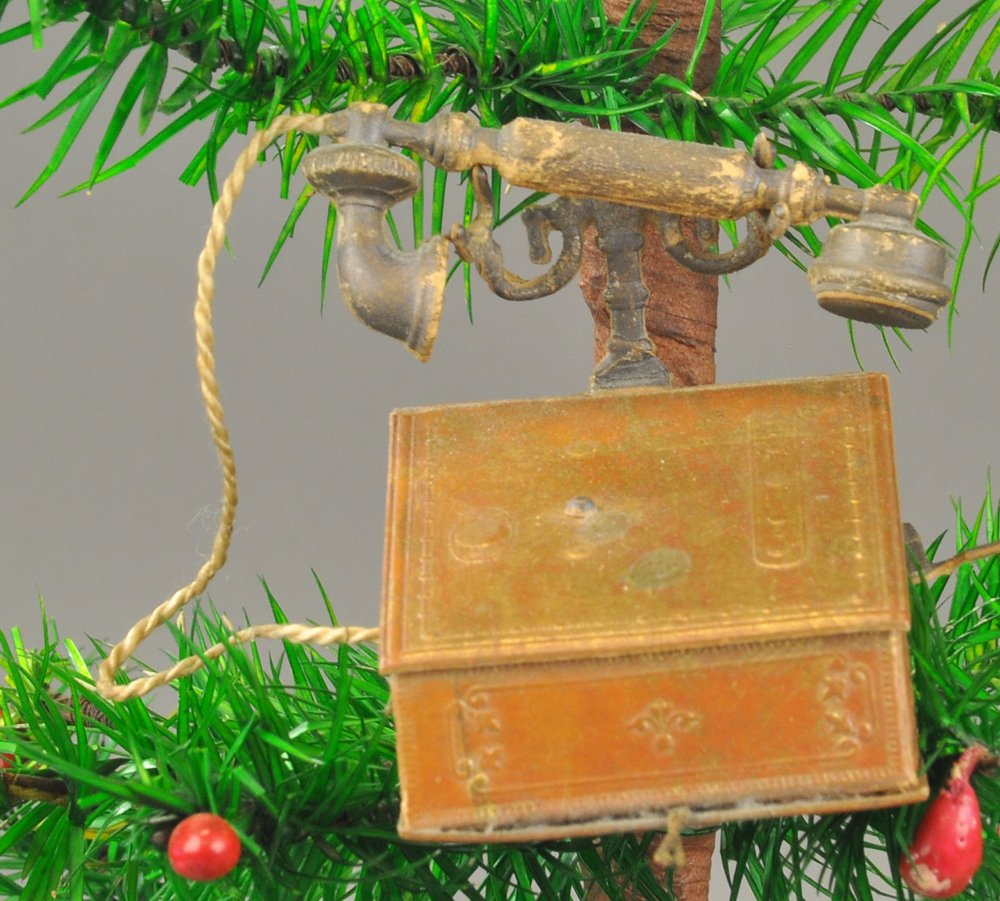 DESK TOP CRANK TELEPHONE DRESDEN ORNAMENT: Interesting depiction of a desk mounted early telephone, nice details & form. 2 1/2" h. Ex. Tom Fox Collection.