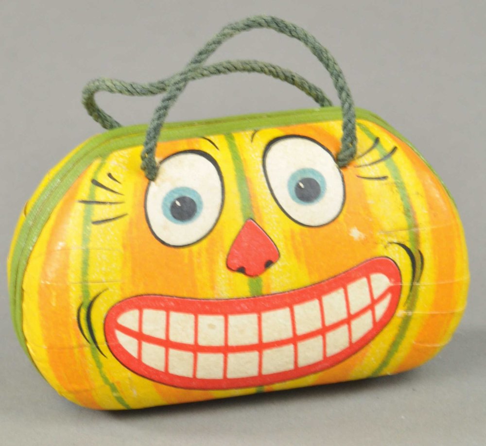 JACK-O-LANTERN PURSE CANDY CONTAINER: Exceptionally rare Jack-O-Lantern litho cardboard German purse, purse opens to put candy inside, exceptional detailing and superb condition. 2" w. Ex. Tom Fox Collection.