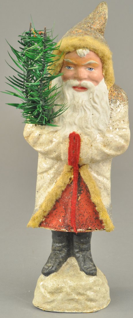 RARE OPEN COAT BELSNICKLE CANDY CONTAINER: Early German composition Belsnickle, white robe topped with mica flecked gold, pipe cleaner red trim and fur trim on hood & open part of coat. 10" l. Ex. Tom Fox Collection.