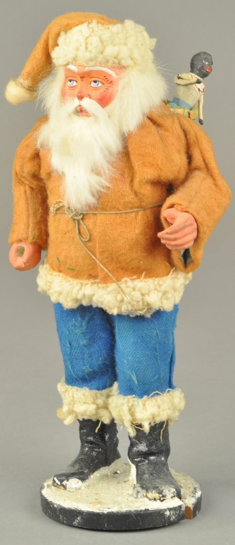 GERMAN SANTA WITH BACKPACK: Red coat over blue pants Santa with rabbit fur beard on composition face, carries backpack with bottle of champagne, "F.A.O. Schwartz" sticker on base. 8 1/2" l. Ex. Tom Fox Collection.