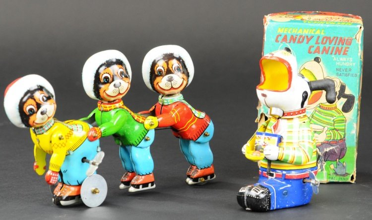 LOT OF TWO JAPANESE TOYS: TPS, both lithographed tin, includes the popular three skating bears and candy loving canine with tattered box, still contains original plastic candy ball. 5 1/2" h - 8 1/2" l.