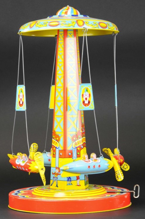 RIDE-A-ROCKET: Chein, tall runabout, done in lithographed tin, features space ships with children, celluloid propellers, wind-up mechanism. 18" h.