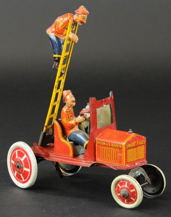 MARX 'SNOOPY GUS' HOOK AND LADDER: Lithographed tin, a zany toy that features figure on extended ladder and seated driver with dog at side, open red auto is key wind driven, ladder swivels when operated. 8" l.