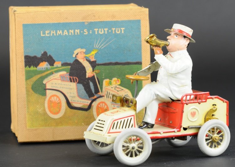 LEHMANN TUT-TUT WITH BOX: Germany, boxed example, lithographed tin open auto, features whimsical portly driver in white suit and hat, holding horn in hand, clockwork driven, well detailed. 6 3/4" h.
