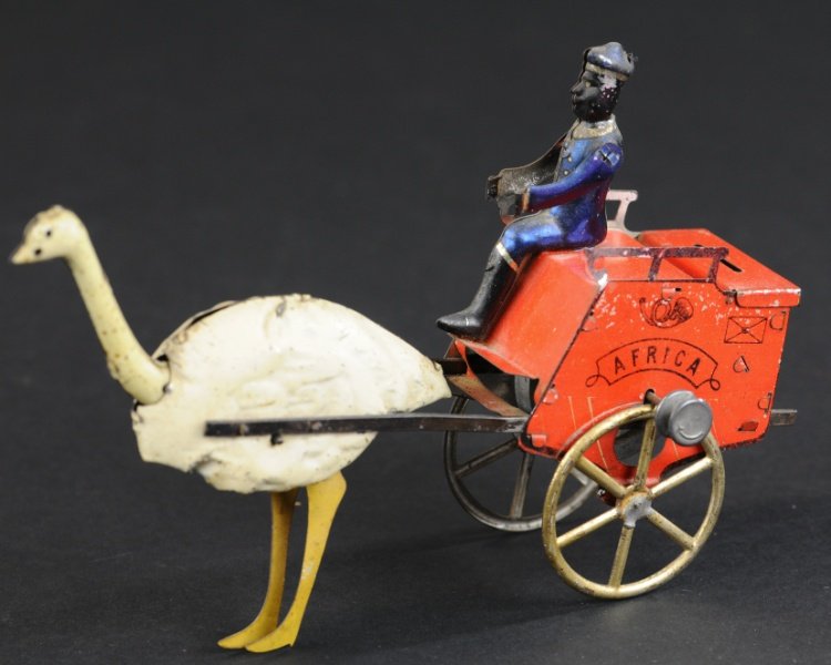 LEHMANN AFRICA OSTRICH CART: Germany, c. 1905, tinplate cart finished in red with driver dressed in blue outfit, drawn by a single ostrich, toy propelled by string flywheel. 7 1/2" l.