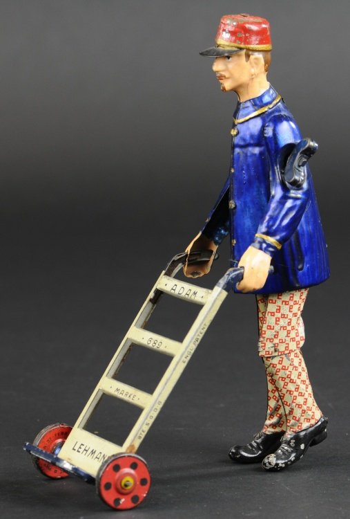 LEHMANN ADAM THE PORTER: Germany, hand painted and lithographed tin, curious toy depicts a porter pushing hand car, clockwork driven, great action. 8" h.