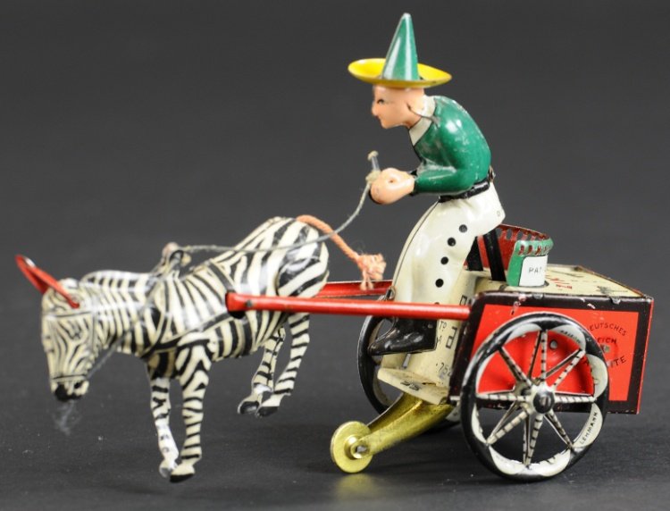 ZIKRA DARE DEVIL: Lehmann, Germany, lithographed tin driver seated on open seat cart pulled by zebra, clockwork action. 7" l.