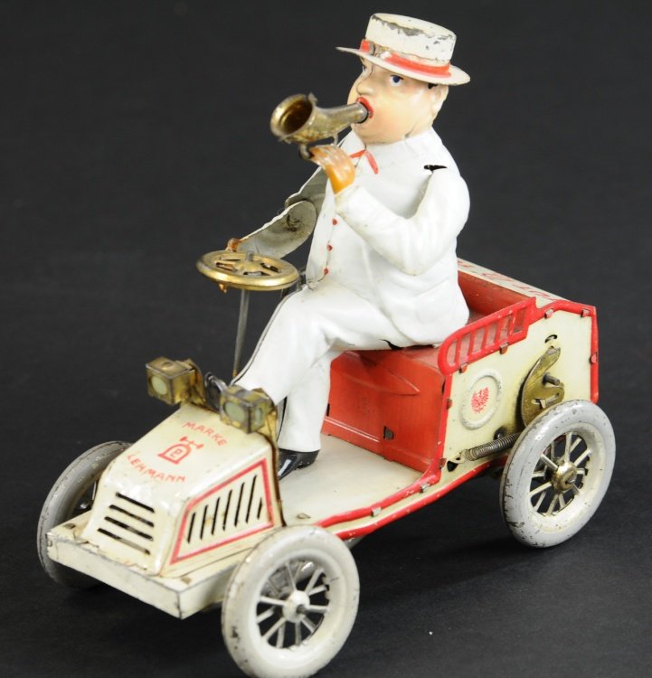 LEHMANN TUT-TUT: Germany, lithographed tin open auto, features portly driver in full white suit and hat, holding horn in hand as if sounding his way down the street, clockwork driven, well detailed. 6 3/4" l.